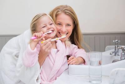 mom with daughter brushing teeth | emergency dentist scarborough