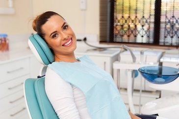 woman sitting in dentist exam chair | cosmetic dentist scarborough