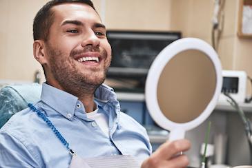 A man smiling after receiving a dental crown service in Scarborough ON