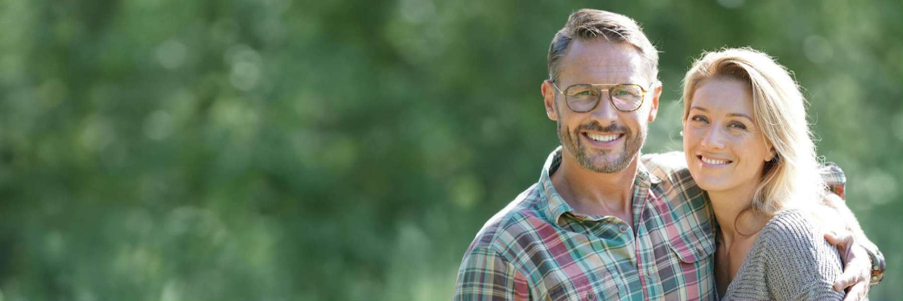A couple smiling after getting Affordable and Reliable Dental Implants in Scarborough, ON