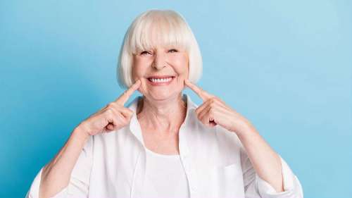 A elderly woman smiling after getting Affordable and Reliable Dental Implants in Scarborough, ON