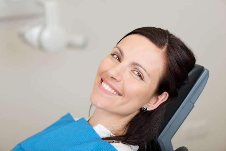 A woman smiling after getting Root Canal Treatment in Scarborough, ON