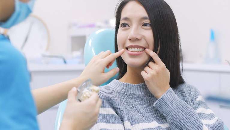 woman sitting in exam chair | general dentist scarborough