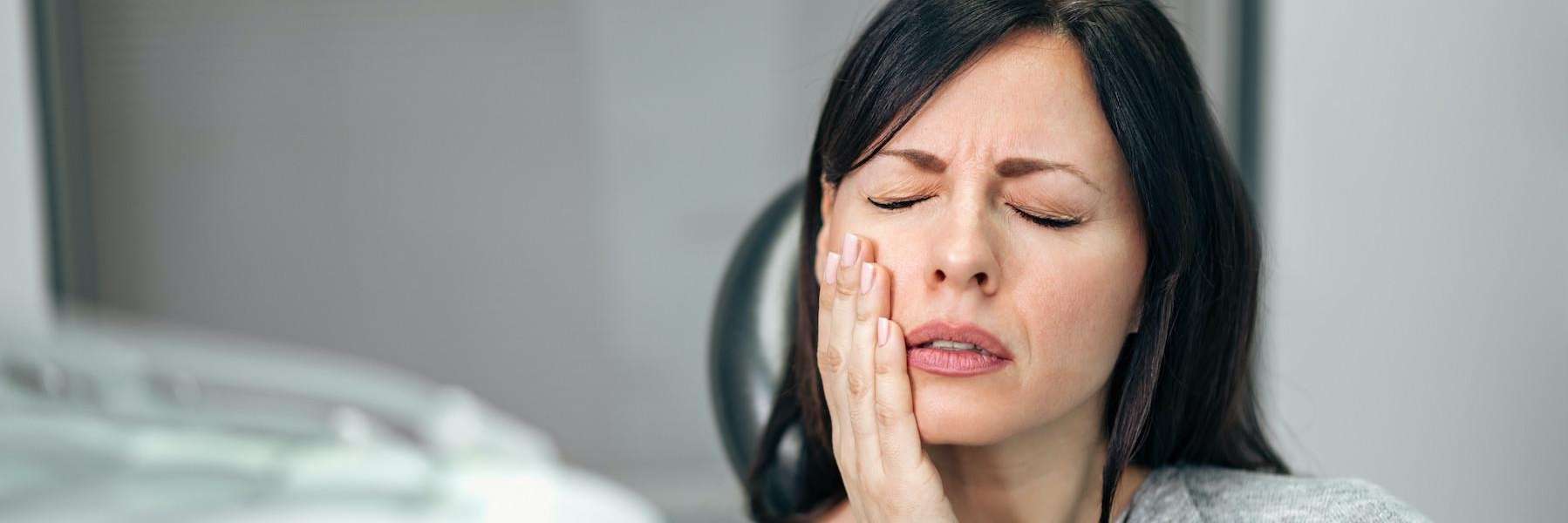 woman in pain holding jaw | root canal treatment scarborough
