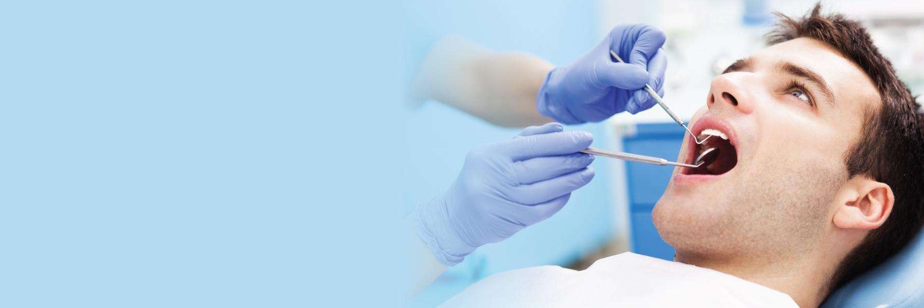 man receiving dental care | tooth extractions scarborough on
